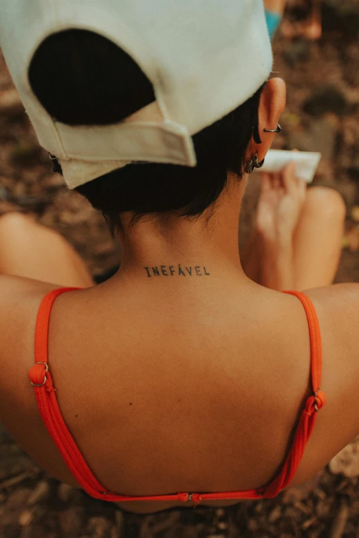 a woman wearing a cap with the words fenne written on her back