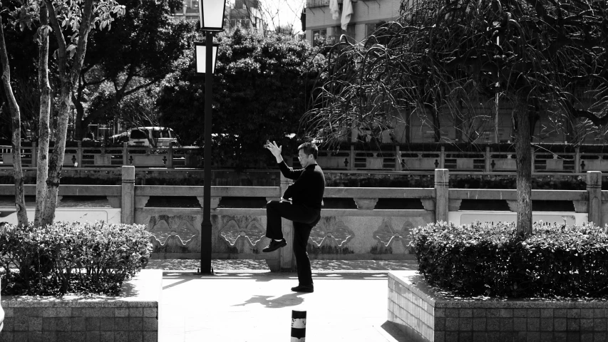 man in suit throwing up a paper airplane