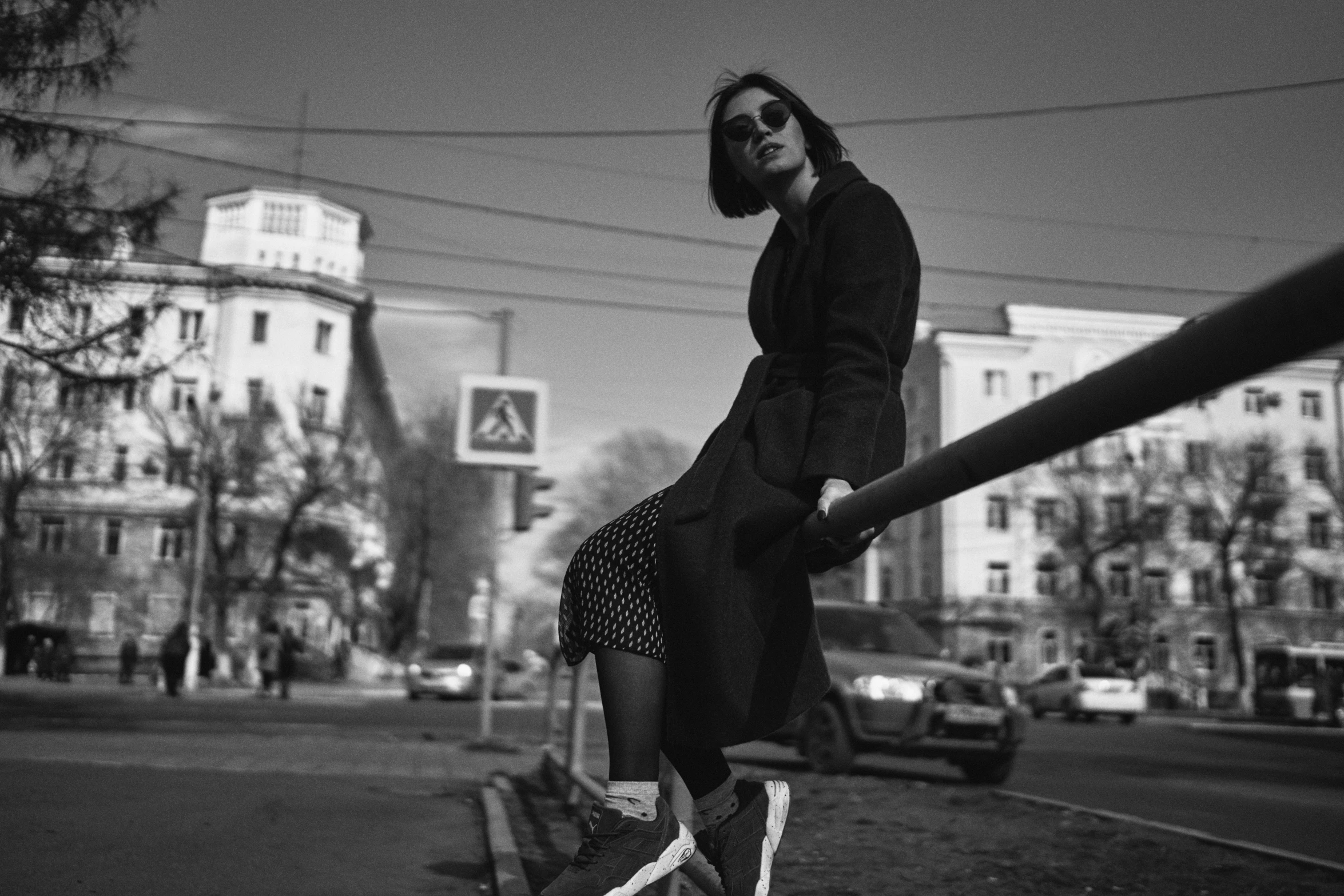 a woman wearing sunglasses holding onto a baseball bat