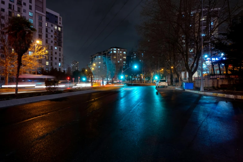 dark city street at night with lights on and dark sky