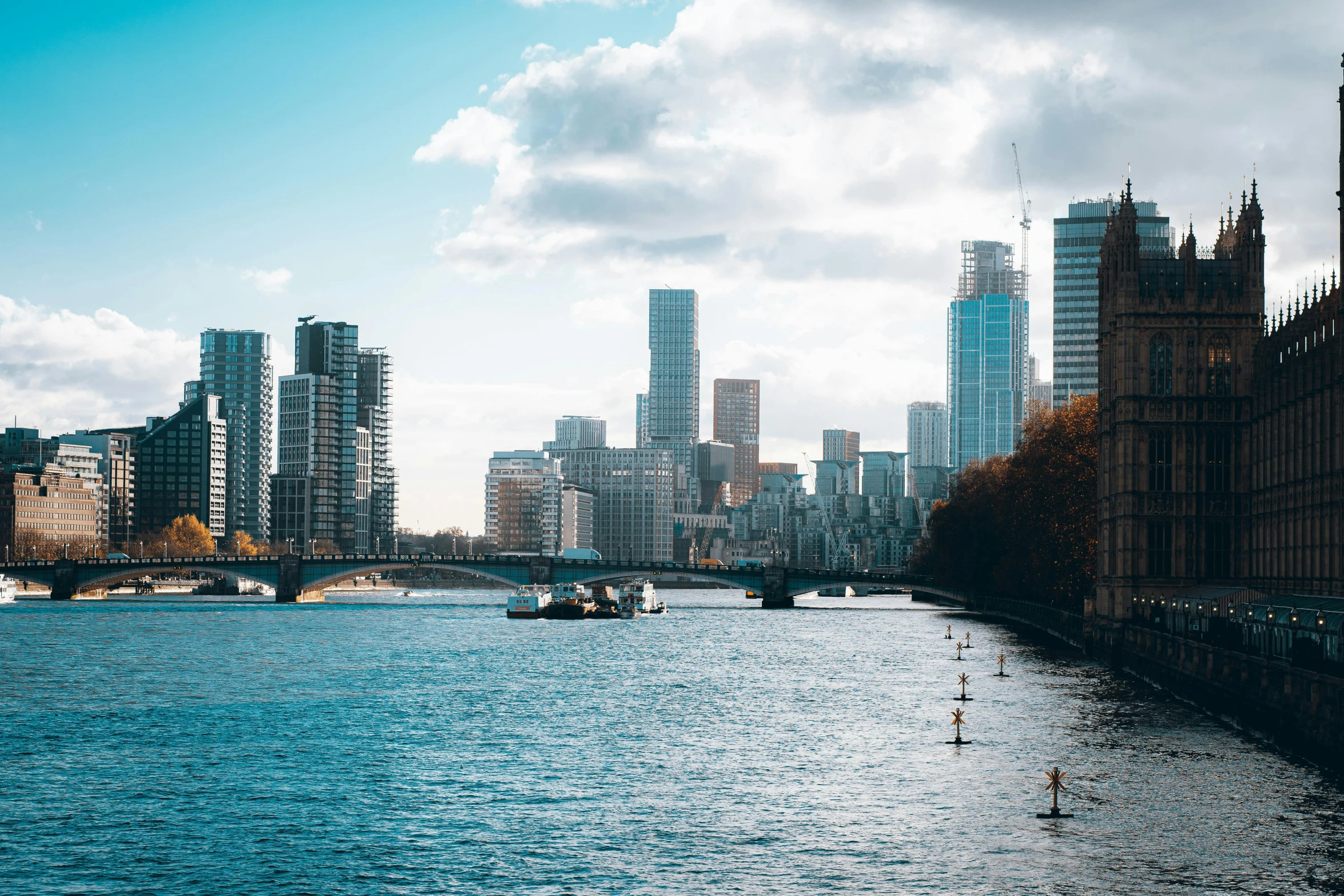 view of boats on river next to city with sky