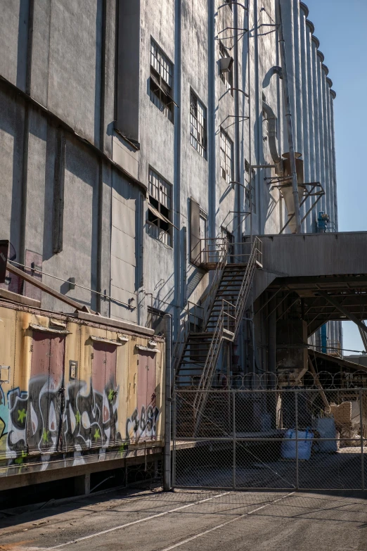 an industrial building with graffiti on the side