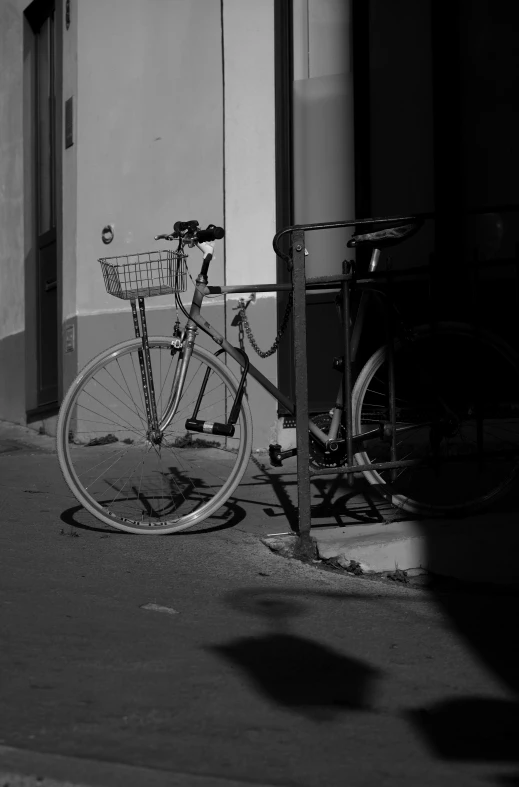 black and white pograph of a bike leaned against a wall