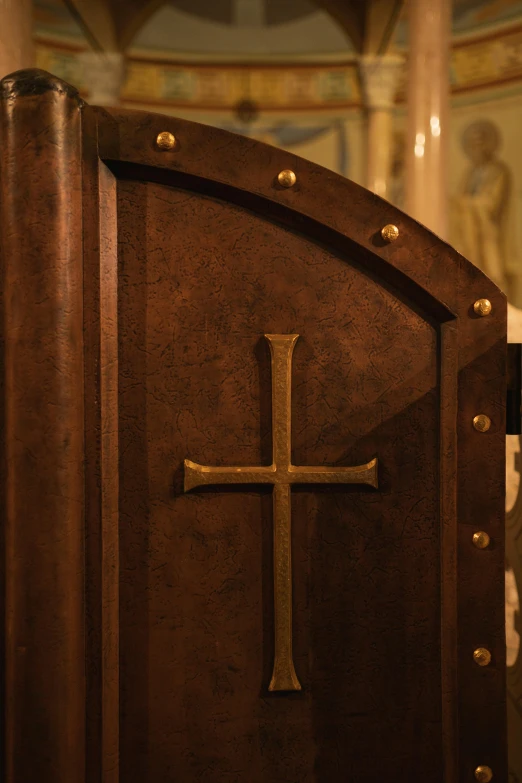 a wood door with a cross on the front of it