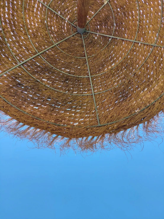 an open umbrella with blue skies in the background