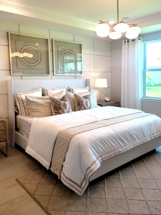 a large white bed sitting inside of a bedroom