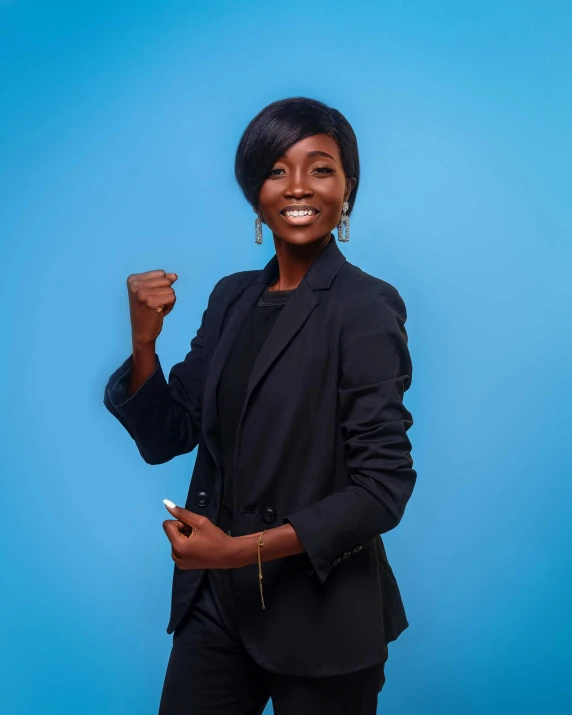 an african american woman standing in front of a blue wall