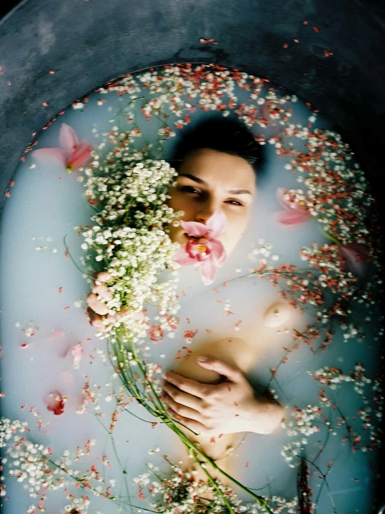 a woman laying in a round, cement structure