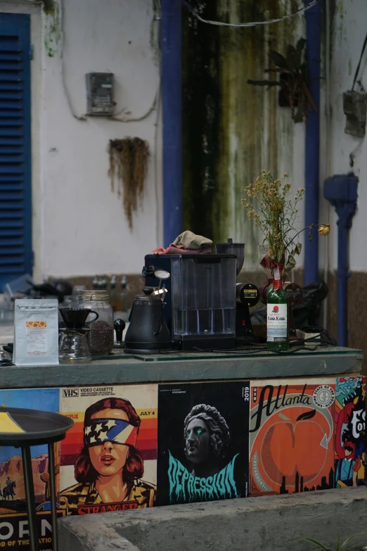 a shelf with many posters and signs on it