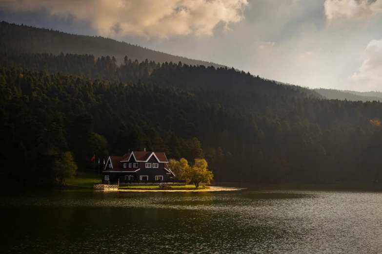 a house sitting on top of a green mountain