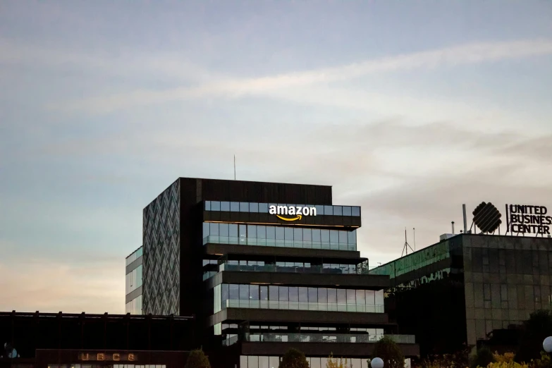 a picture of two buildings with a cloudy sky