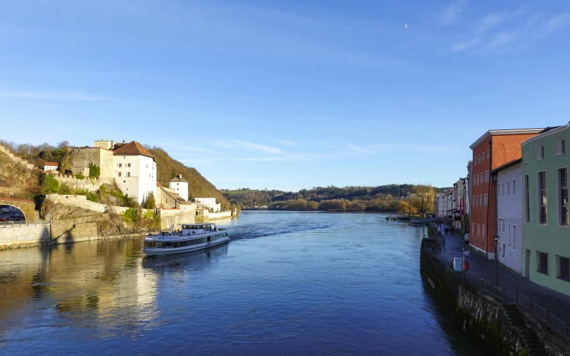 river with boats near many different buildings next to street