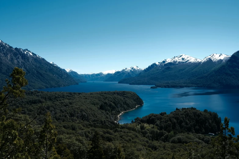 the view of trees, mountain range, water and mountains