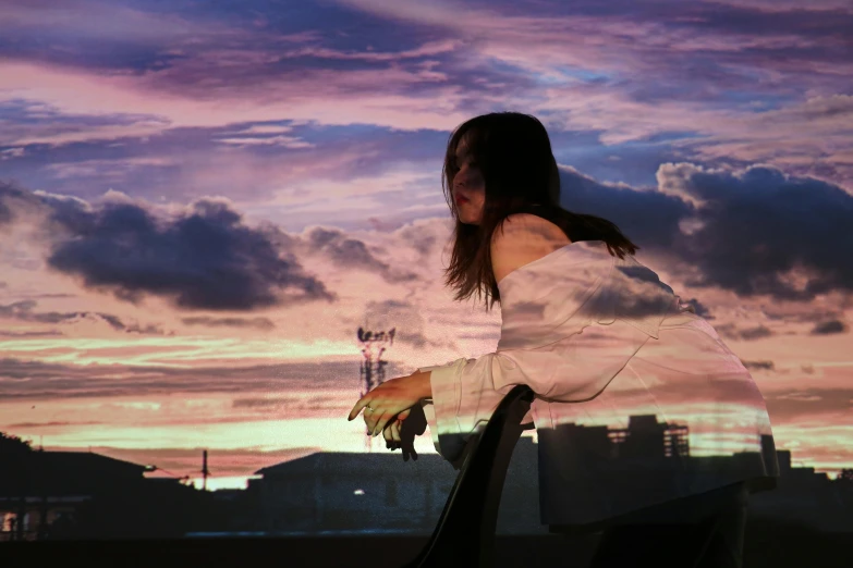 a woman is posing for a po at sunset