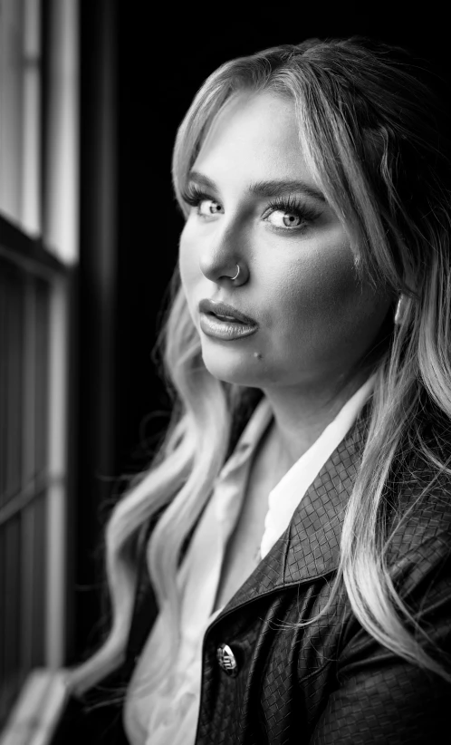 a woman is posing for a picture in black and white