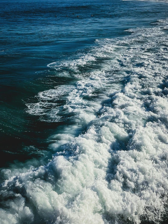 a view from the back of a ship out on the ocean