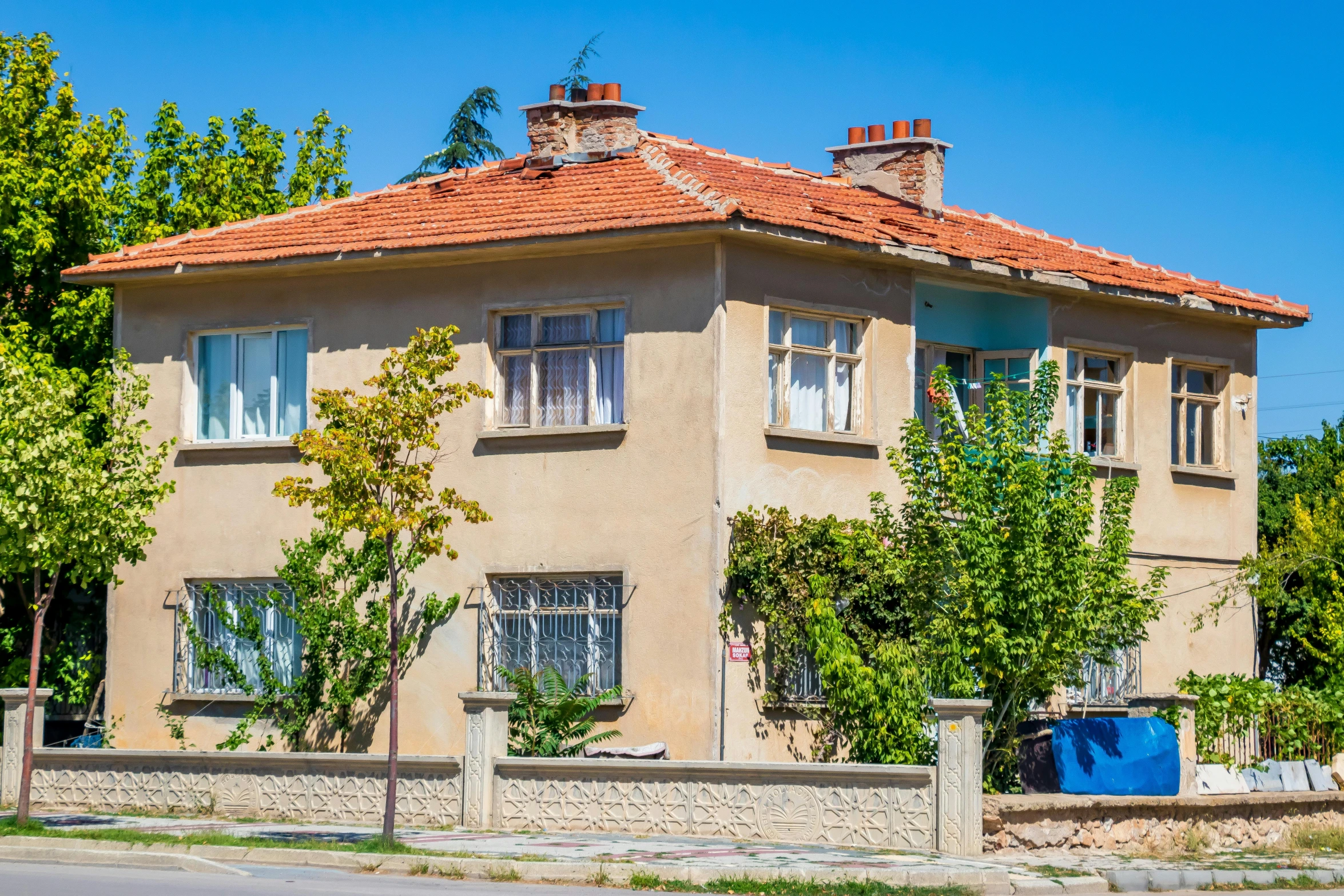 a brick house with chimneys on the roof