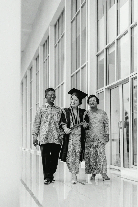 a group of asian people standing in front of a window