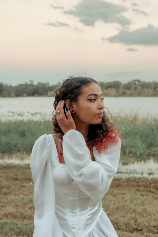 a woman wearing earrings and a dress