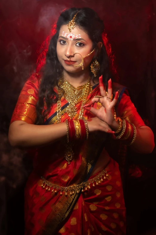 a beautiful woman in red posing in front of smoke