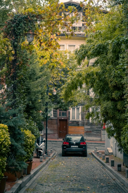 a black car in front of some big buildings