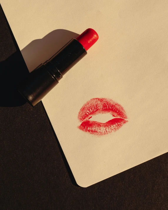 a red lipstick sticker with a kiss drawn on it