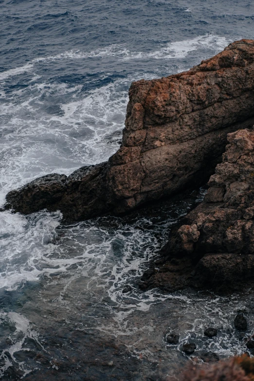 an ocean with some rocks and water around it