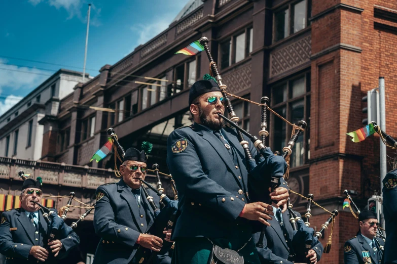 a group of men dressed in blue marching uniforms