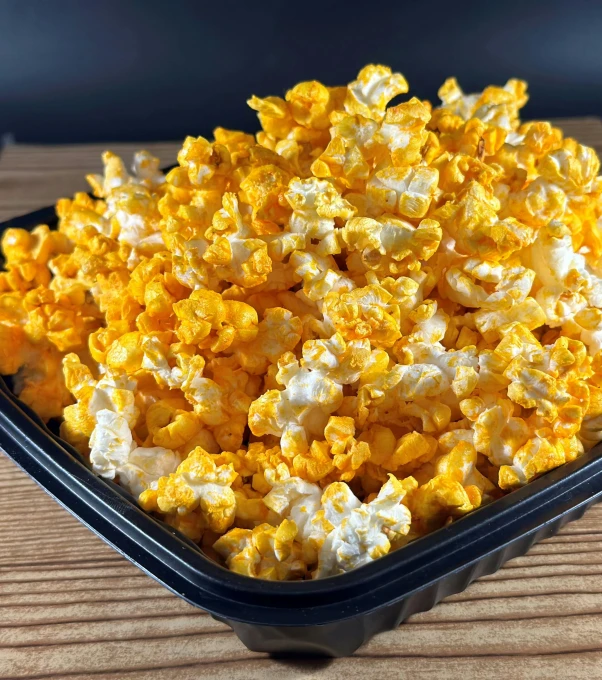 a plate full of popcorn sits on the table