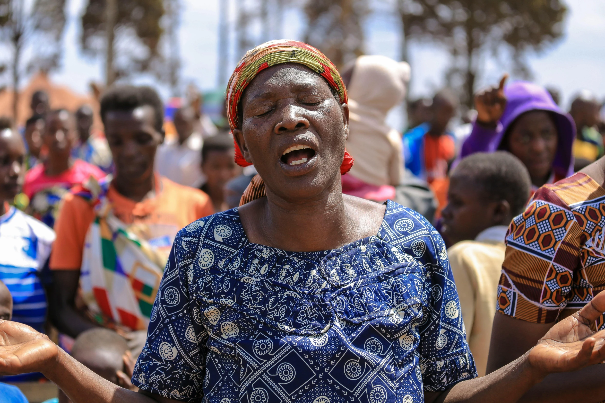 a group of people are gathered together, some wearing head scarves