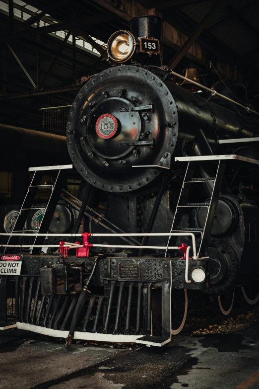 an old steam engine sitting inside of a building