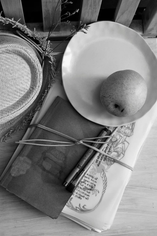 a plate, bowl, and other objects are arranged on a wooden table