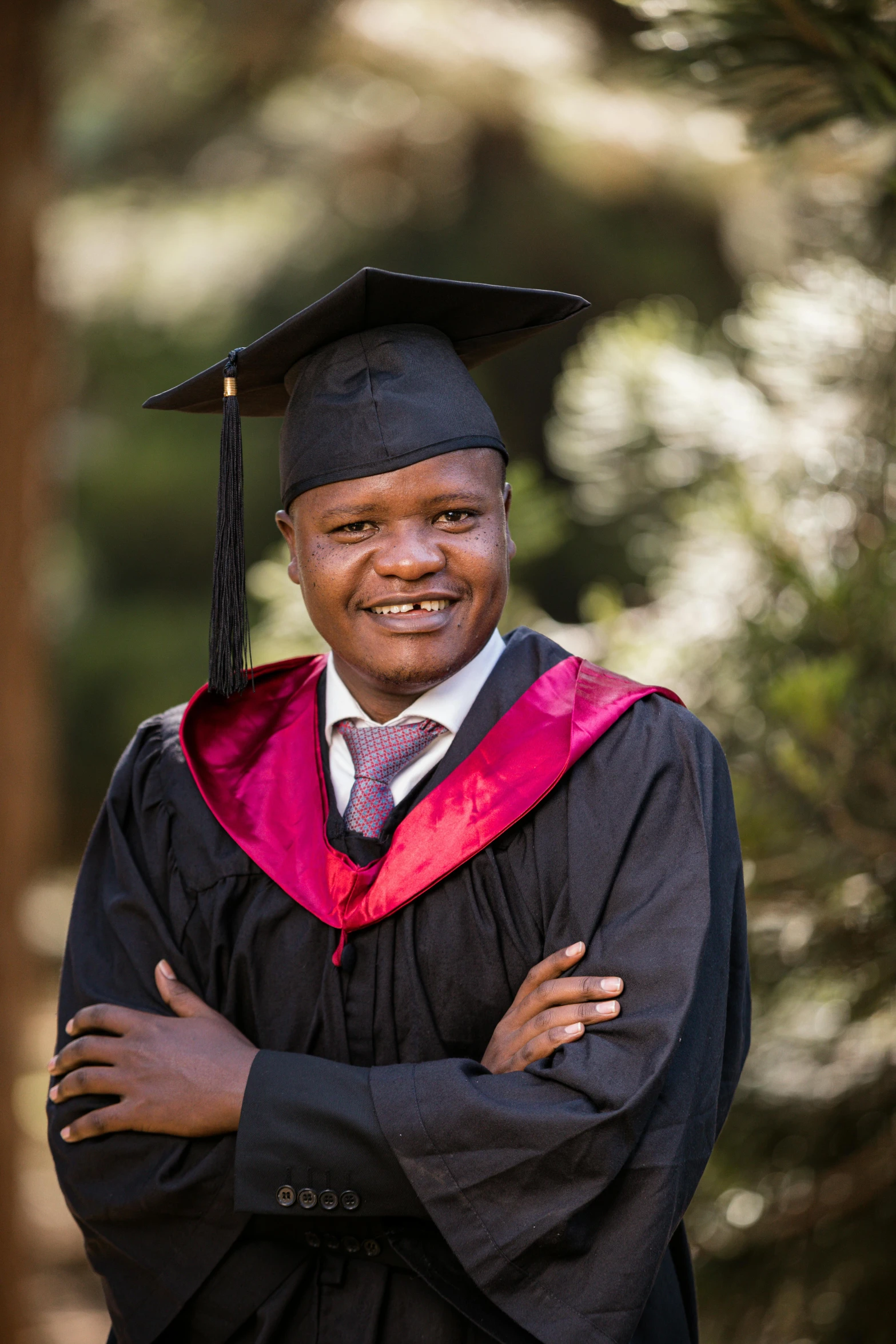 an african american male in graduation regaline posing for the camera