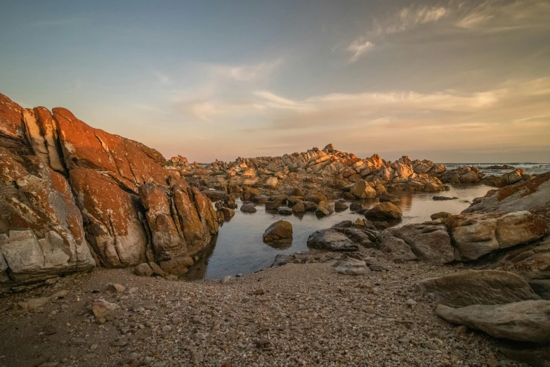 the rock formations at sunset at the beach