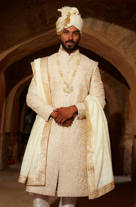a man dressed in a white and gold costume
