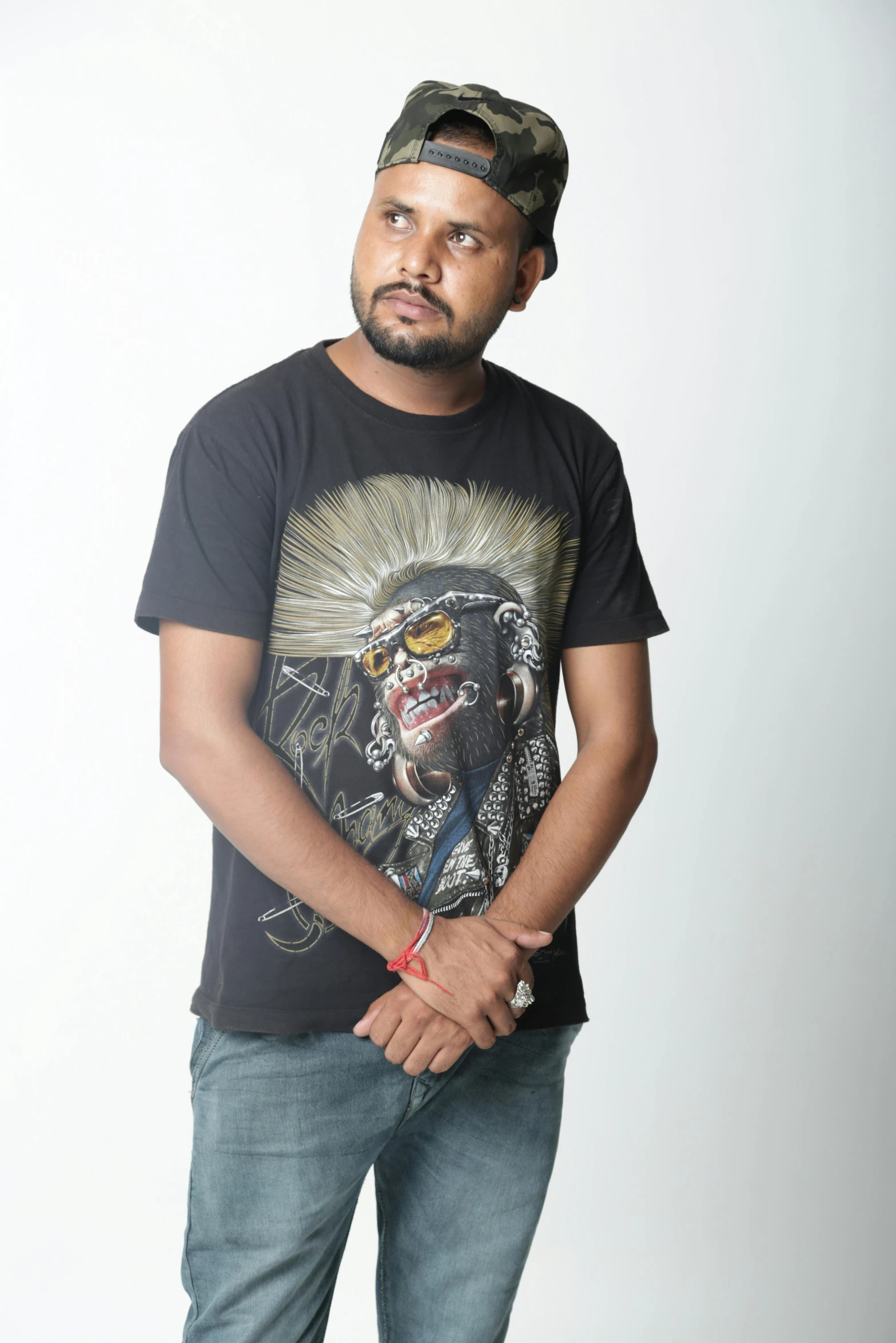 a young man poses for the camera with his arms crossed