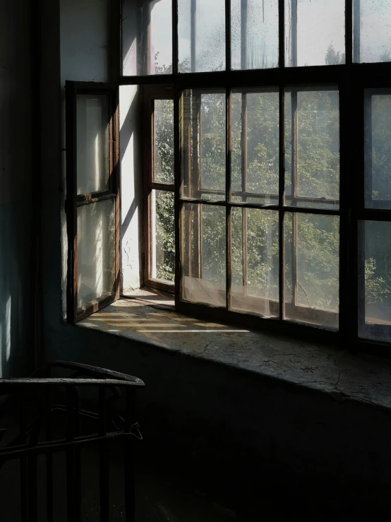 an old room has a window with a curtain