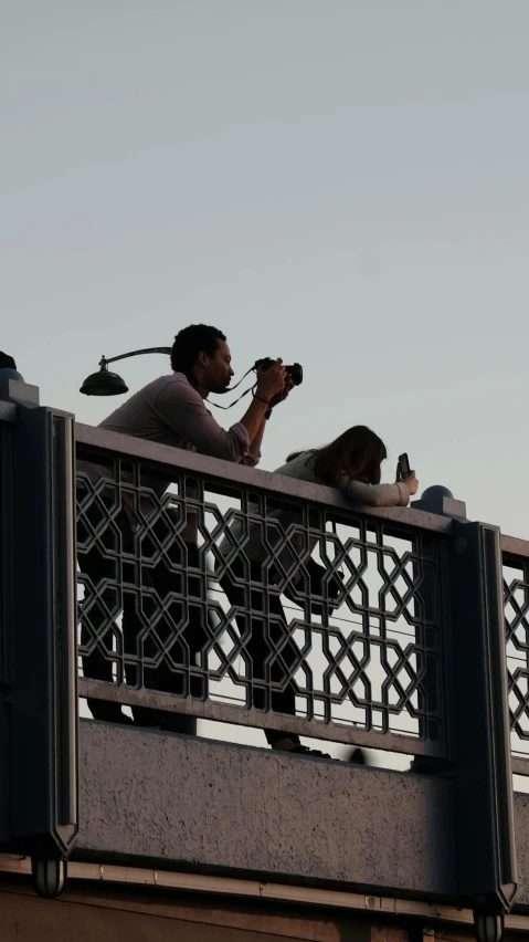 a man looking into the distance from a bridge with bikes