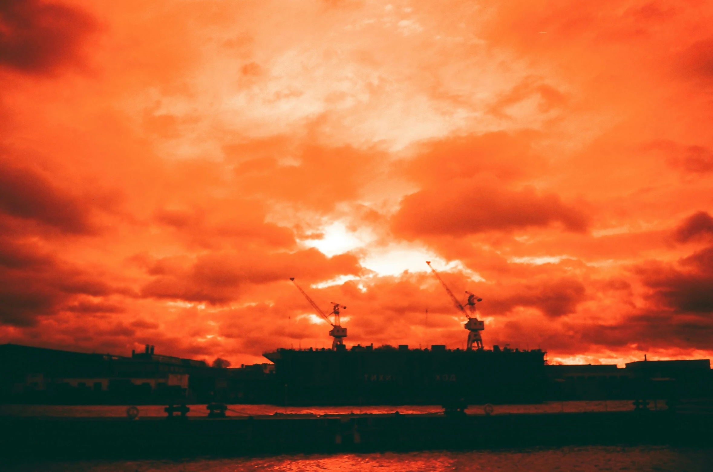 a big boat traveling through the ocean at sunset