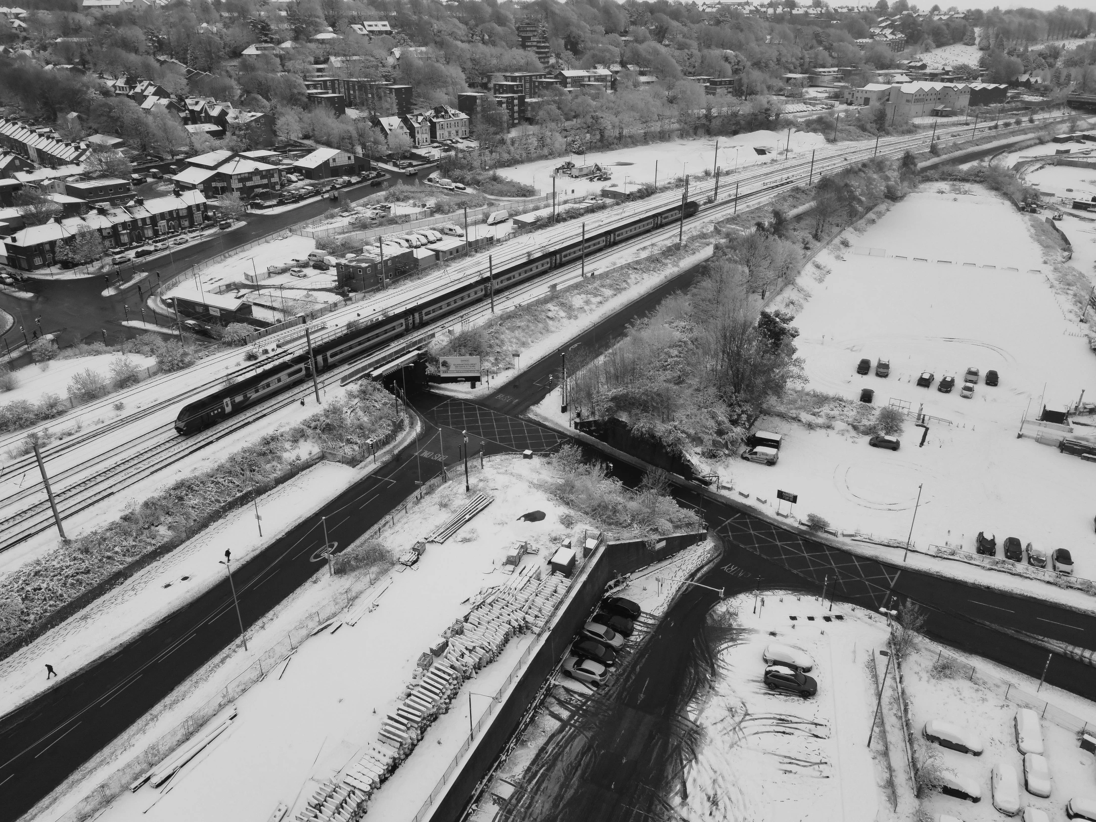 an aerial view of several railroad tracks in winter