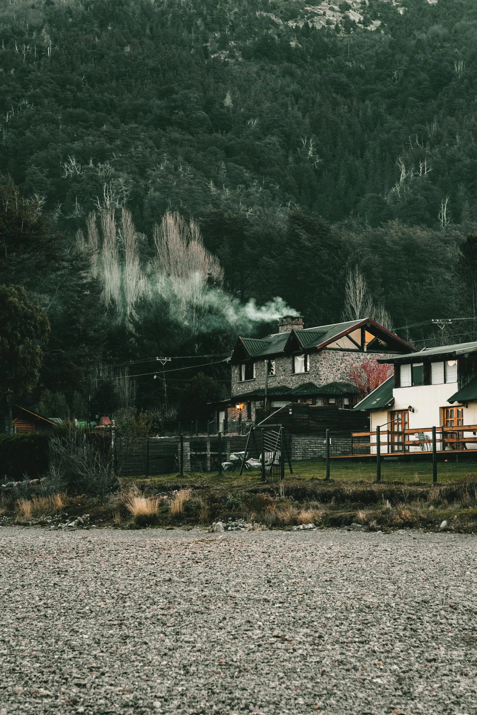 an old wooden house next to the water