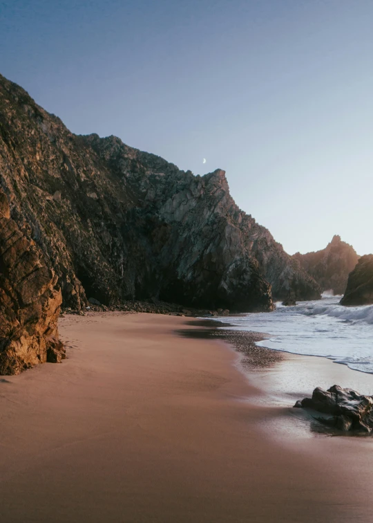 a beach with a mountain in the background