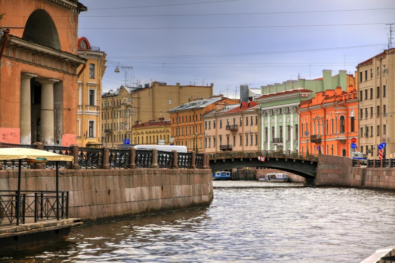 a river running through a small village near tall buildings