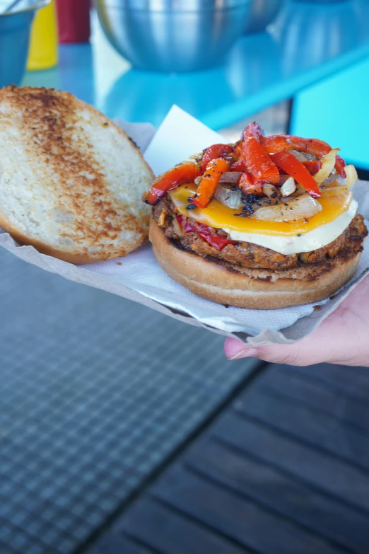 sandwich that contains several different foods on a bun