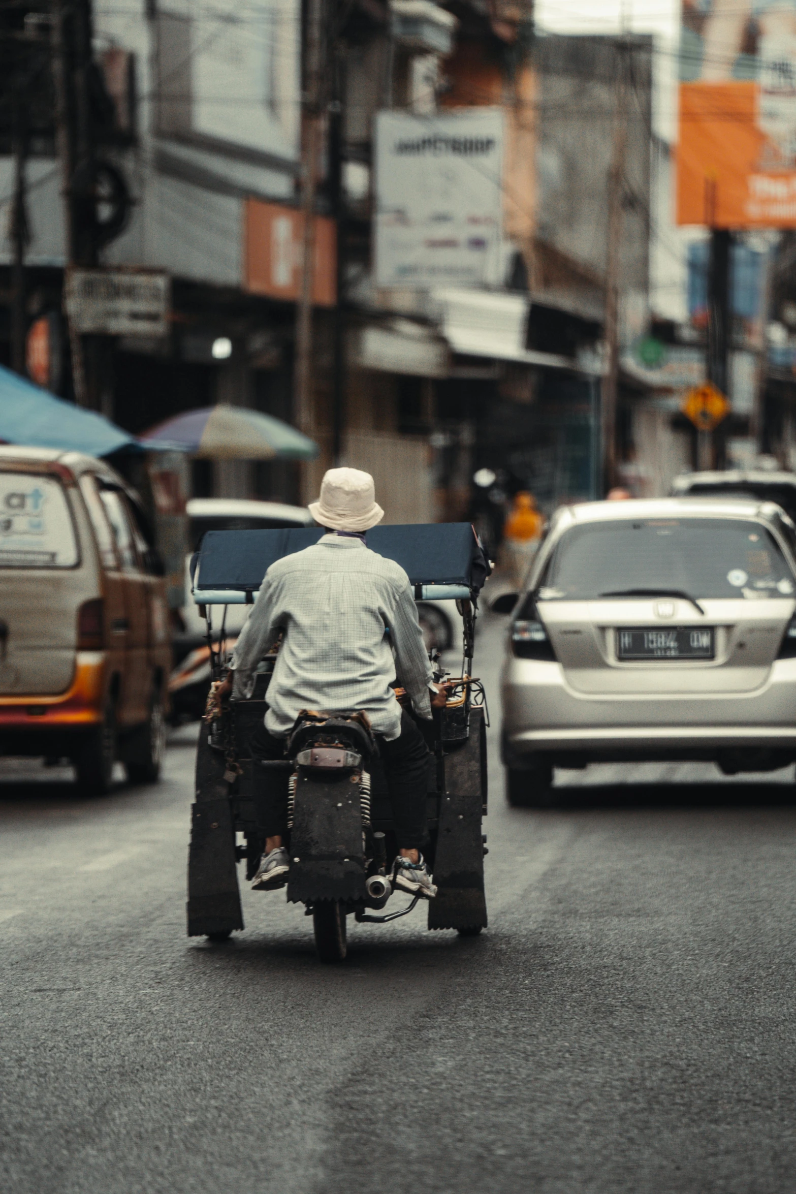 man in the middle of a crowded street with two bikes