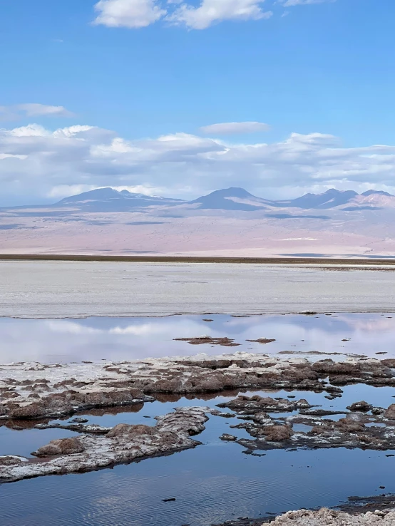 a body of water near land and mountains