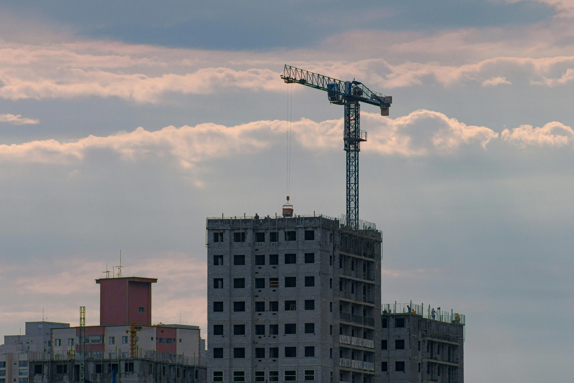 a crane that is on top of a large building