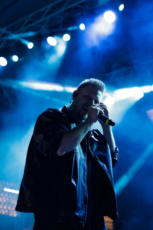 the singer in front of some stage lights