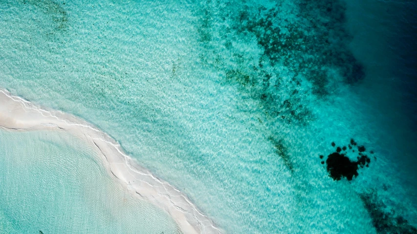 aerial view of an island surrounded by blue water