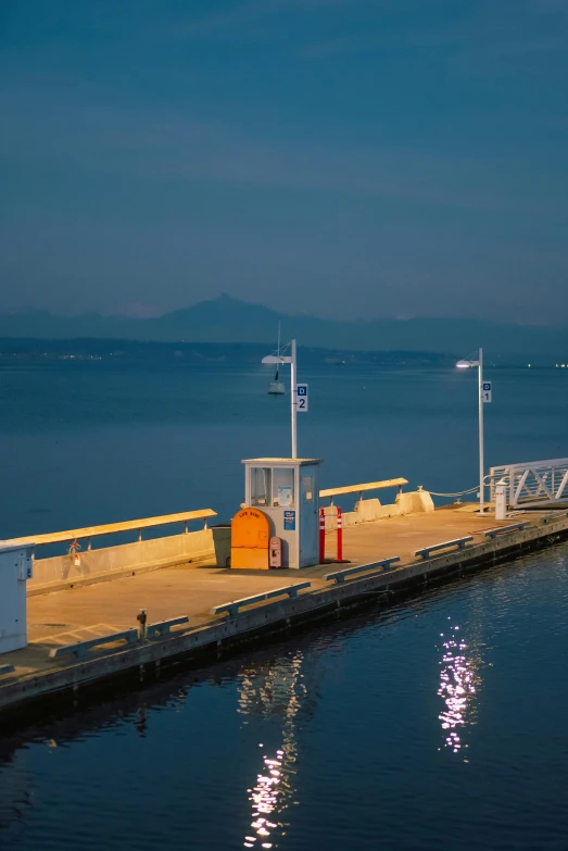 a boat on a lake near a dock at night